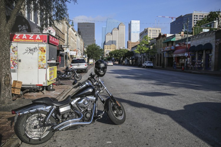 Some abandoned bikes are parked on the streets after an early morning shooting on Saturday, June 12 in downtown Austin, Texas. 