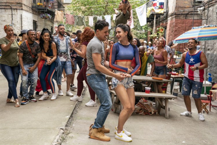 Anthony Ramos, foreground left, and Melissa Barrera in a scene from "In the Heights." 