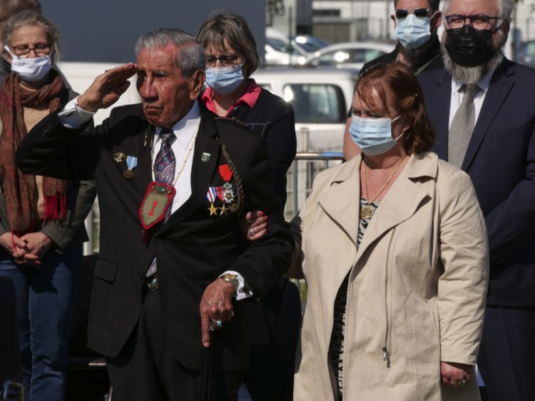 Charles Shay, the 96-year-old native American from Indian Island, Maine, salutes during a D-Day ceremony in Carentan, Normandy, on Friday. In a small Normandy town where paratroopers landed in the early hours of D-Day, applauds broke the silence to honor Shay. He was the only veteran to attend the ceremony in Carentan commemorating the 77th anniversary of the assault that led to the end World War II. Shay was a 19-year-old U.S. Army medic when he landed on Omaha Beach. 
