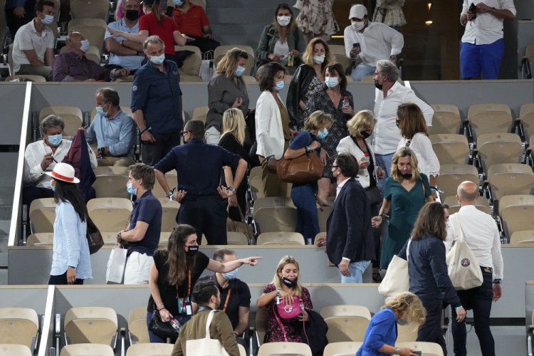 Spectators leave a French Open match in June in Paris in order to adhere to an 11 p.m. coronavirus curfew. European nations are employing a variety of requirements and limitations that pressure people to get vaccinated. 