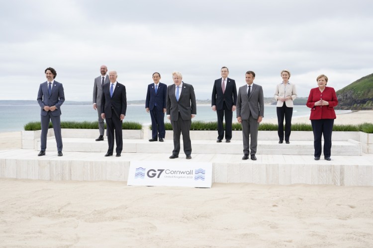 Leaders of the G-7 gather for a group photo overlooking the beach at the Carbis Bay Hotel in Cornwall, England, on Friday. From left are Canadian Prime Minister Justin Trudeau, European Council President Charles Michel, U.S. President Biden, Japan's Prime Minister Yoshihide Suga, British Prime Minister Boris Johnson, Italy's Prime Minister Mario Draghi, French President Emmanuel Macron, European Commission President Ursula von der Leyen and German Chancellor Angela Merkel. 