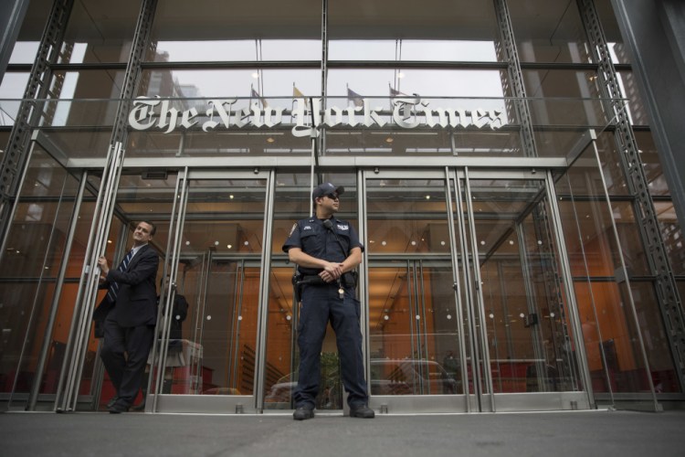A police officer stands outside The New York Times building in New York in 2018. 


