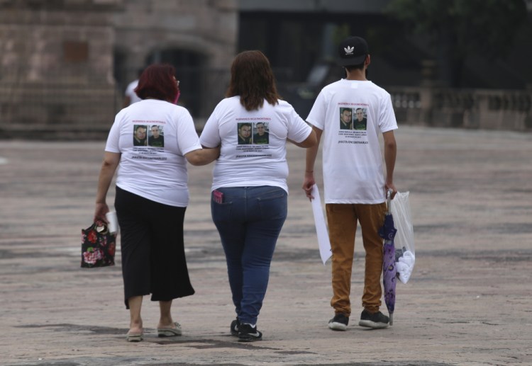 Family members wear T-shirts with photos of disappeared Jorge Arevelo and Ricardo Valdes, during a protest in Monterrey, Nuevo Leon state, Mexico, on Thursday. As many as 50 people in Mexico are missing after they set off on simple highway trips between the industrial hub of Monterrey and the border city of Nuevo Laredo; relatives say they simply disappeared on the heavily traveled road, which has been dubbed ‘the highway of death,’ never to be seen again. 