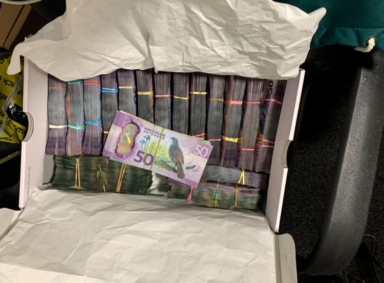 A box containing a large amount of cash is displayed after being discovered during a police raid as part of Operation Trojan Shield. Authorities in Australia and New Zealand on Tuesday, said they’ve dealt a huge blow against organized crime after hundreds of criminals were tricked into using a messaging app that was being secretly run by the FBI. 