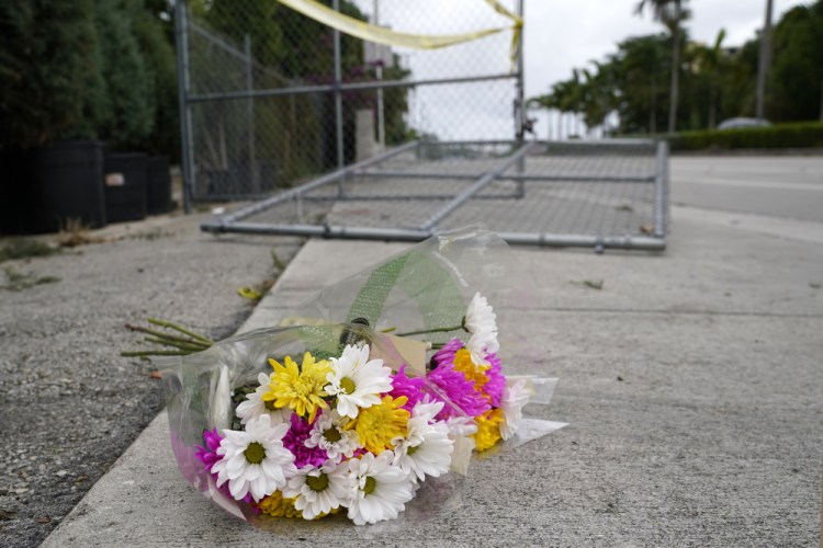 Flowers lie at the scene where a driver slammed into spectators at the start of a Pride parade Saturday evening, killing one man and seriously injuring another, Sunday in Fort Lauderdale, Fla.