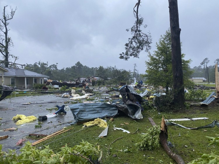 Debris covers the street in East Brewton, Ala., on Saturday.  Authorities in Alabama say a suspected tornado spurred by Tropical Storm Claudette demolished or badly damaged at least 50 homes in the small town just north of the Florida border.

  