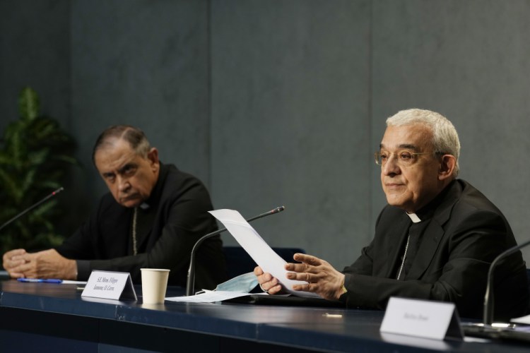 Monsignors Filippo Iannone, right, and Juan Ignacio Arrieta Ochoa de Chinchetru hold a news conference to describe changes in the Church's Canon law, at the Vatican on Tuesday. Pope Francis has changed church law to explicitly criminalize the sexual abuse of adults by priests and to say that laypeople who hold church office can be sanctioned for similar sex crimes. 