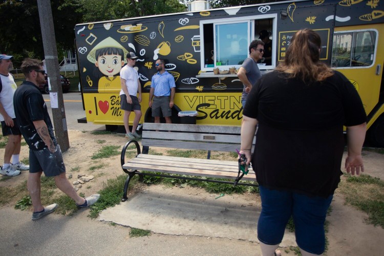 PORTLAND, ME - JUNE 30: Customers wait for food at one of the food trucks along the Eastern Promenade on Wednesday. (Staff photo by Derek Davis/Staff Photographer)
