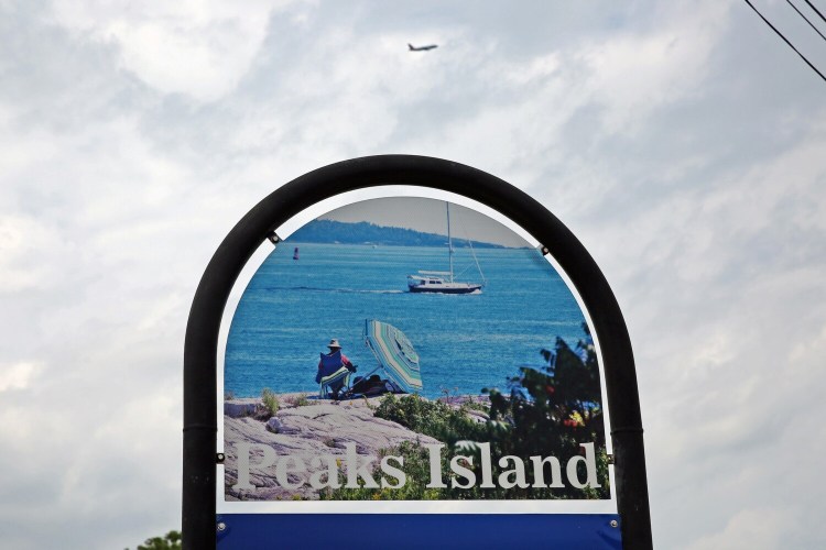 PORTLAND, ME - JULY 7: A passenger plane departing from Portland International Jetport flies toward the north end of Peaks Island on Wednesday afternoon. (Staff photo by Ben McCanna/Staff Photographer)