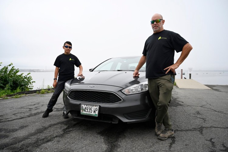 Entrepreneur Jeffrey Laverdiere, right, and his 13-year-old son, Sam, run a fleet of cars that they rent on an app called Turo. They posed with one of their cars in Portland on Wednesday.
