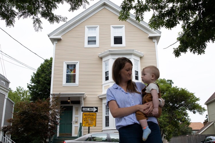 PORTLAND, ME - JULY 13: Kaili Moore with her 11-month old son Teddy at her apartment building on May Street in Portland. Moore manages over 100 apartments with her husband. (Staff photo by Derek Davis/Staff Photographer)