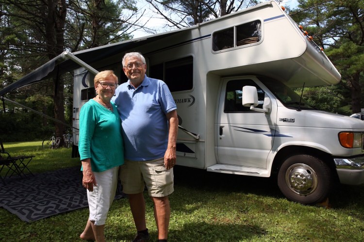 FREEPORT, ME - JULY 22: Diane and Roger Lavertu of Lewiston stand by their recreational vehicle at a campsite within Winslow Park and Campground in Freeport. With a surge in camping during the pandemic in 2020 -- a year that saw record numbers at state park campgrounds -- many camping regulars found it hard to get their choice spot, and those who did felt like they won the lottery. For some, getting their favorite campsite is a stressful endeavor each winter, and the pandemic made planning their favorite vacation even more stressful. (Staff photo by Ben McCanna/Staff Photographer)