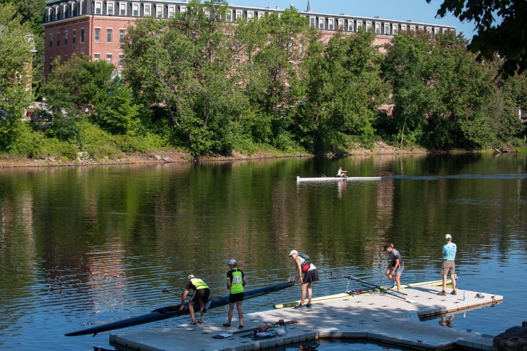 Racers load and unload their shells at the temporary dock at Simard-Payne Memorial Park in Lewiston during the L/A Riverfest regatta in July 2020. Lewiston Rowing has secured funding to install a permanent dock at the location, which was one of the goals of the Riverfront Island Master Plan. 