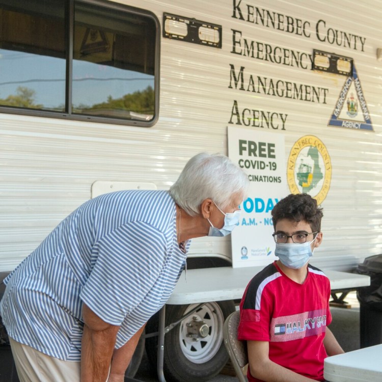 Nurse vaccinator Marlene Viger chats with Ahmad Alsaleh as he waits 15 minutes after getting a COVID-19 vaccination Thursday during a popup clinic at the Augusta Food Bank. A popup vaccination clinic was set up in the Kennebec County Emergency Management Agency's trailer at the food bank and there were plans for them to return in three weeks so people who got the shot that day could get a second dose.