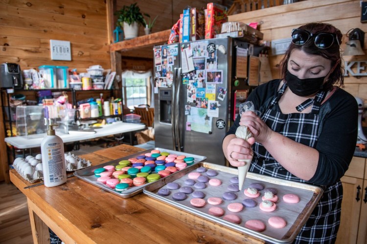 Jenna Roberts fills pink macarons on Saturday at her home based bakery Marvelous Macarons in Lewiston for the Bakes for Breast Cancer fundraiser.