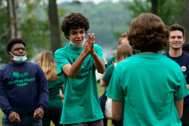 Camper Joel Kalai, of Lexington, Mass., takes part in a game at the Seeds of Peace summer camp Monday in Otisfield.