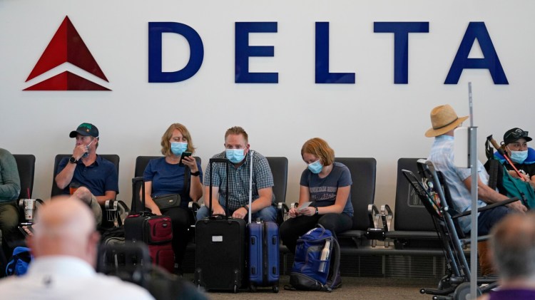 People wait for their flight at Salt Lake City International Airport on July 1. A Delta survey of its corporate customers finds that only 57 percent plan to be back to full travel by the end of 2023.