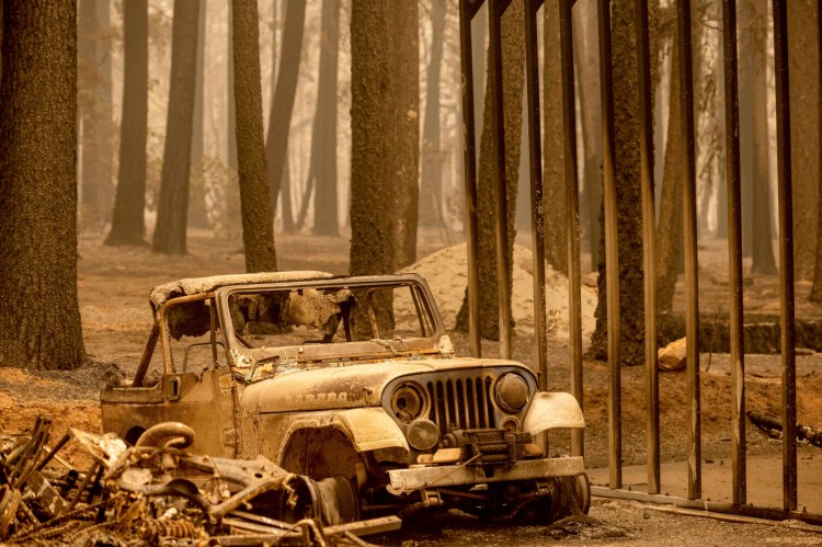 Following the Dixie Fire, a scorched Jeep rests in the Indian Falls community of Plumas County, Calif., on Monday, July 26, 2021. (AP Photo/Noah Berger)