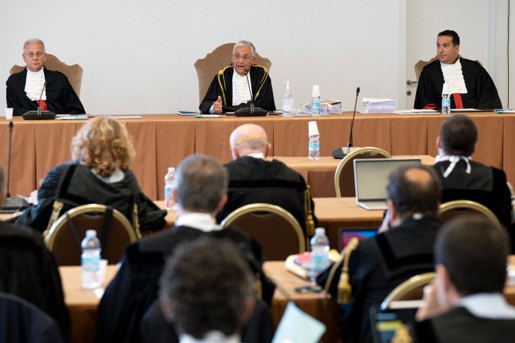 Judge Giuseppe Pignatone, center, presides over a trial at the Vatican, Tuesday, July 27, 2021. A trial has opened in Vatican City for 10 defendants, including a once-powerful cardinal, for roles in the allegedly criminal management of the Holy See’s portfolio of assets. That wealth included donations by Catholics. The trial is the largest in the modern history of the Vatican city-state and is being held in a hall converted into a courtroom in the Vatican Museums. (Vatican Media via AP)