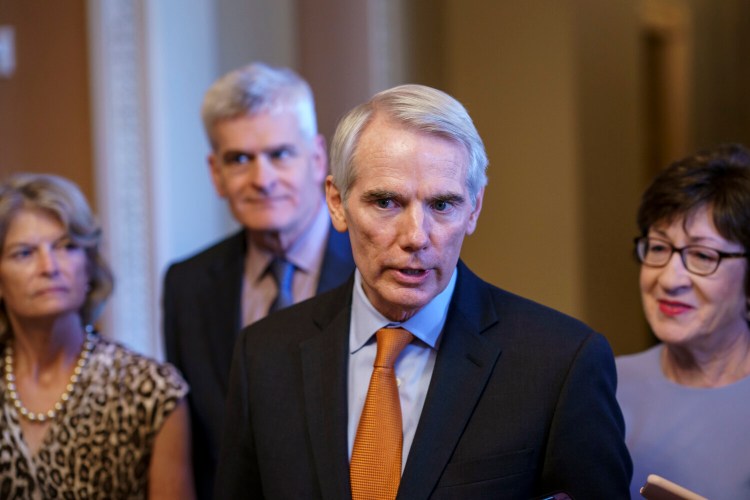 Sen. Rob Portman, R-Ohio, the lead GOP negotiator in the infrastructure talks, is joined by, from left, Sen. Lisa Murkowski, R-Alaska, Sen. Bill Cassidy, R-La., and Sen. Susan Collins, R-Maine, as he announces an agreement with Democrats on a $1 trillion infrastructure bill, saying they are ready to vote to take up the bill, at the Capitol in Washington, Wednesday, July 28, 2021. (AP Photo/J. Scott Applewhite)
