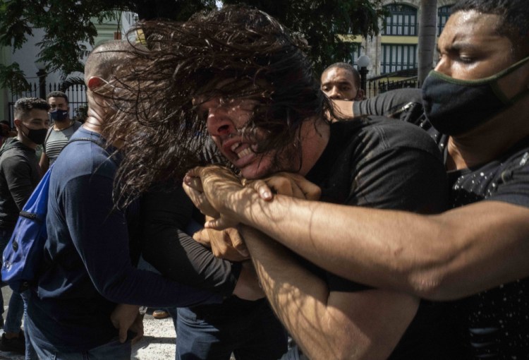Plainclothes police detain an anti-government protester in Havana on Sunday. 

