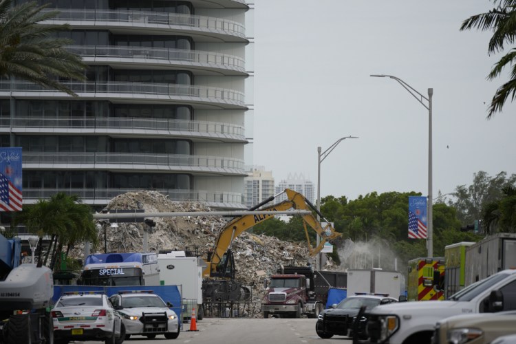 An excavator removes the rubble of the demolished section of the Champlain Towers South building on July 12. 