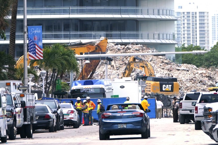 Crews work in the rubble of the Champlain Towers South building, as removal and recovery work continues at the site of the partially collapsed condo building, Tuesday, July 13, in Surfside, Fla. 