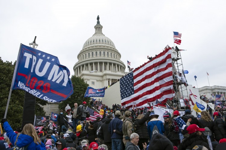 Rioters loyal to then-President Donald Trump outside the U.S. Capitol on Jan. 6 in Washington. Scores of suspects remain unidentified, reflecting the massive scale of the Justice Department's investigation and the grueling work authorities still face to track everyone down. 

