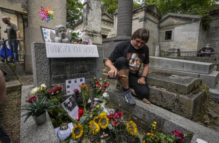 Torsten Marquardt of Germany pours some whiskey on the tomb of rock singer Jim Morrison at the Pere-Lachaise cemetery in Paris on Saturday.