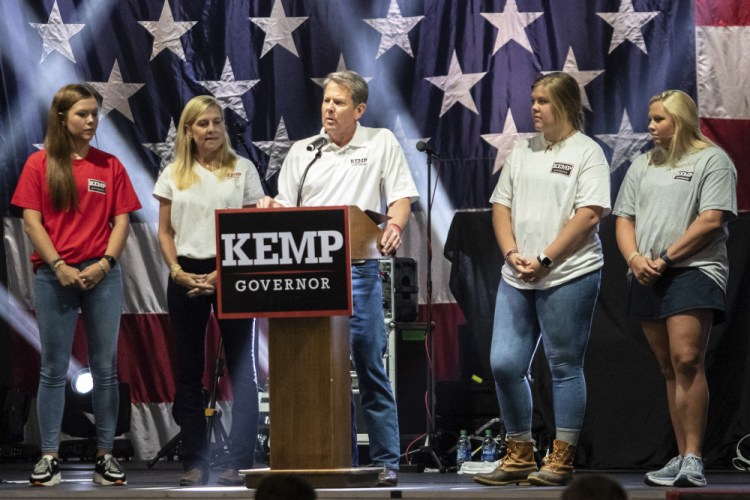 Gov. Brian Kemp announces his bid for re-election at the Georgia National Fairgrounds surrounded by his family on Saturday in Perry, Ga.   