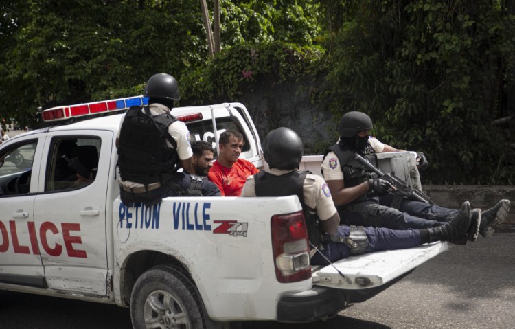 The police take two detainees to the police station of Petion Ville in Port-au-Prince, Haiti, Thursday, July 8, 2021. According to Police Chief Leon Charles, the two detained are suspects in the assassination of Haitian President Jovenel Moïse. 