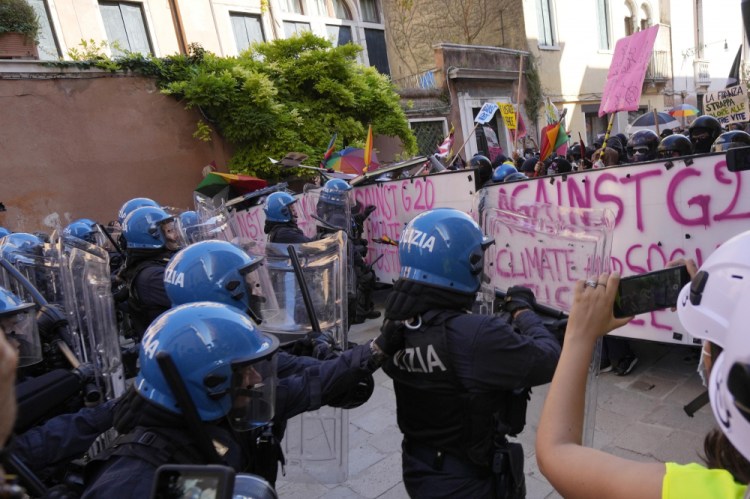 Italian police in riot gear clash with demonstrators during a protest against the G-20 meeting in Venice, Italy, on Saturday.

