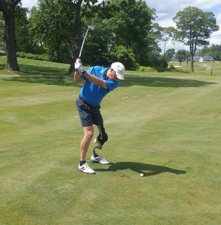 John LeMieux takes a swing at his approach shot at Samoset Golf Course in Rockland. LeMieux is the founder of the Maine Amputee Open, heading into its fifth year.