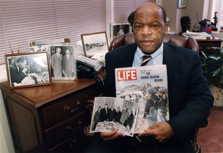 Rep. John Lewis is seen in his Atlanta office with two of his favorite items from his collection of memorabilia from his younger days as a civil rights activist in the 1960s. He is holding a Life magazine cover picturing the famous Selma march in 1965. (He is in this photo at front of the line of marchers.) He is also holding a photo of the "Big Six" civil rights leaders of the time to plan for the famous March on Washington. The men in the photo are John Lewis, from left, Whitney Young, A. Phillip Randolph, Martin Luther King, James Farmer and Roy Wilkins. I

Atlanta Journal-Constitution via AP