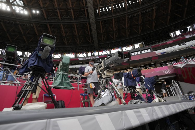 Cameramen work at the Olympics on Saturday in Tokyo. 



