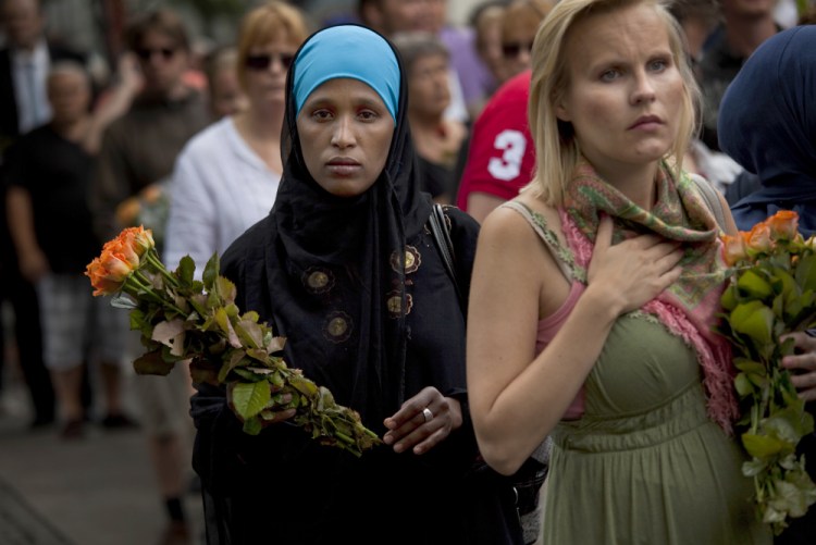On July 24, 2011, women carry flowers as they arrive for a memorial service at Oslo Cathedral in the aftermath of the bombing and shooting attacks on Norway's government headquarters and a youth retreat, in Oslo. 