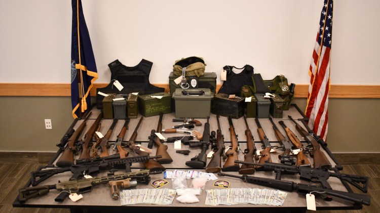 Police seized 36 firearms, thousands of rounds of ammunition and fake police identification, among other items, from a home in Old Orchard Beach on Sunday.