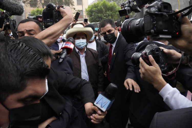 Pedro Castillo is surrounded by journalists June 15 as he arrives at his campaign headquarters t in Lima, Peru. 

