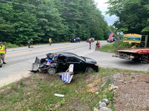 Police say a distracted driver drove into the back of a Toyota Camry in Standish Wednesday, sending a woman and three children to the hospital.
