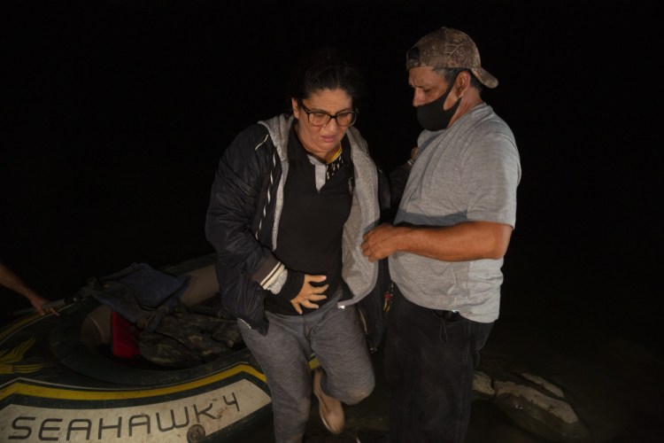 Mayra Culio from Guatemala is helped off an inflatable raft by a church volunteer after being smuggled across the Rio Grande river in Roma, Texas, in March. Assailants shot her 7 times at her house and then killed her husband who was ambushed in his car in Escuintla, Guatemala. She was five months pregnant and fled with her extended family March 12 after being treated in the hospital for her bullet wounds. 