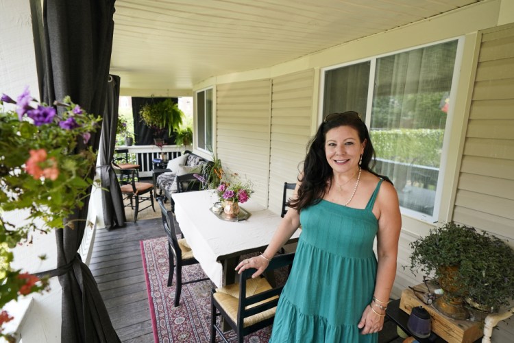 Heather Bise, owner of The House of Bise Bespoke, poses on the front porch where she entertains guests Monday in Cleveland. 
