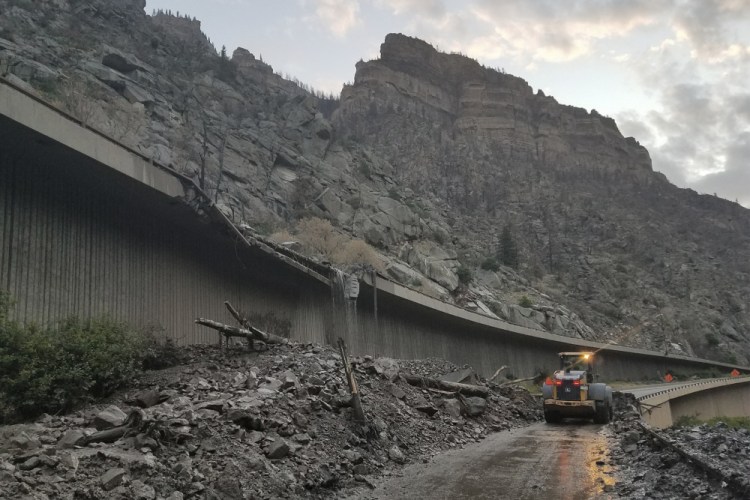 Equipment works to clear mud and debris from a mudslide on Interstate 70 through Glenwood Canyon, Colo., on Friday, July 30, 2021. 

