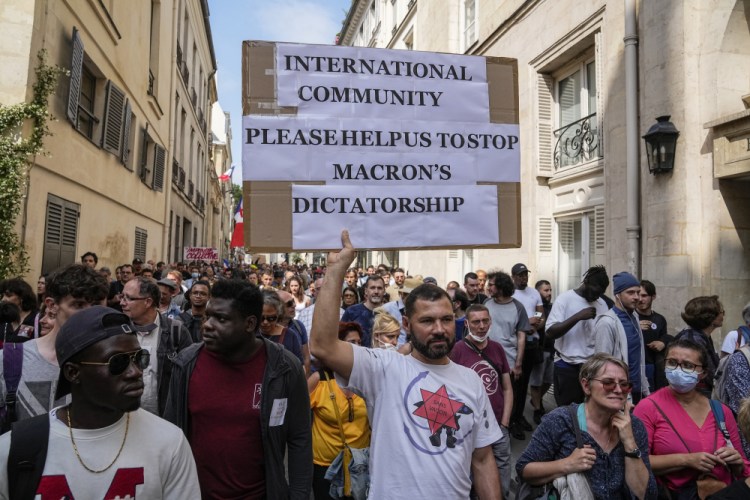 An anti-vaccine protester holds a placard during a rally in Paris on Saturday.

