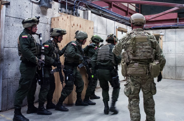 A U.S. Special Forces soldier observes elite Colombian troops during training at Eglin Air Force Base in Florida in 2015. The two militaries have a partnership dating back decades. MUST CREDIT: U.S. Defense Department