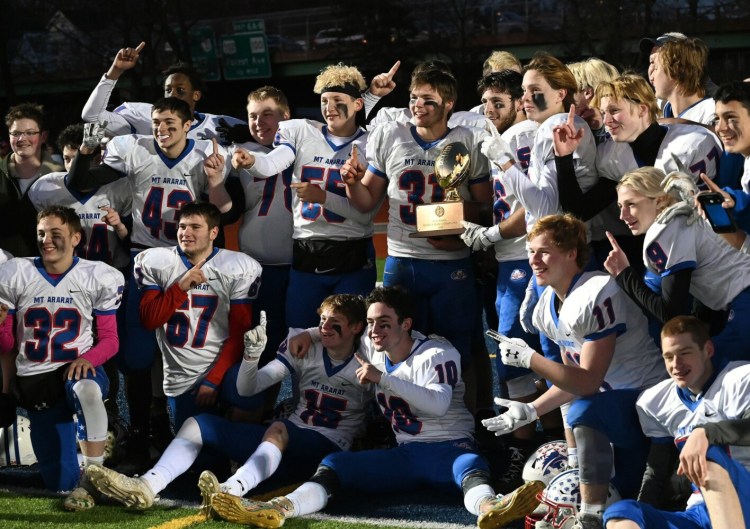 PORTLAND, ME - NOVEMBER 16: Mt. Ararat celebrates with the trophy after winning the 8-man football state championship Saturday Nov. 16, 2019. (Staff Photo by Shawn Patrick Ouellette/Staff Photographer)