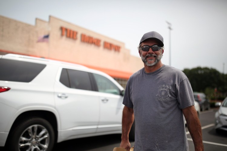 South Portland resident Tom Andrews stands in the Home Depot parking lot in South Portland on Wednesday. Andrews said he recently built a loft and was surprised by the high cost of materials. 