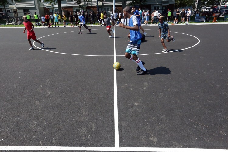 PORTLAND, ME - AUGUST 6:  Futsal players run down court during a demonstration game at an opening ceremony for the newly constructed Futsal Court at Fox Field on Friday morning. Futsal is a soccer-style game on a small scale. Each team has five players, including a goalkeeper, that play on a hard, outdoor surface using a smaller, heavier ball. Each game lasts for one goal or ten minuets, whichever comes first, then new teams or players rotate in. (Staff photo by Ben McCanna/Staff Photographer)