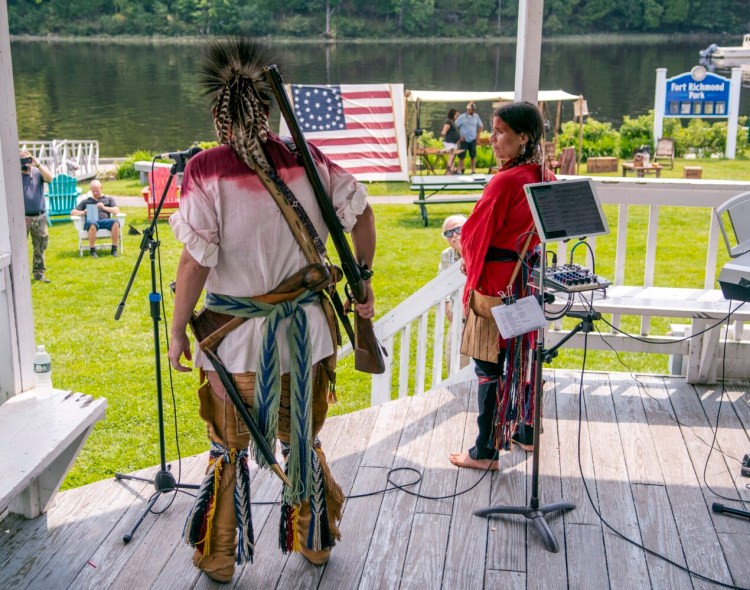 Jonathan Yellowbear, left, and Heather Sprague discuss the history of Abenakis on Swan Island and also the traditional regalia they're wearing during Saturday's bicentennial kickoff in Richmond. Although it has begun celebrating, the town won't officially turn 200 until Feb. 10, 2023.