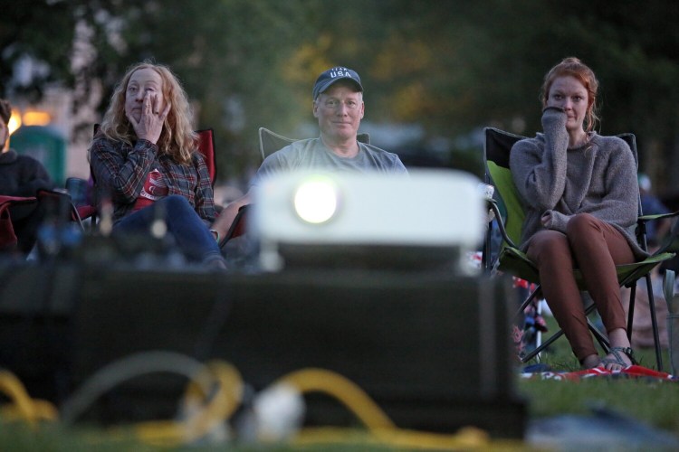 PORTLAND, ME - AUGUST 10: Falmouth paracyclist Clara Brown's immediate family -- stepmother Amanda Murray, left, father Greg Brown and sister Rachel Brown -- get emotional during a short film about Clara Brown called "Ability," which was included in the Maine Outdoor Film Festival on the Eastern Prom on Tuesday. (Staff photo by Ben McCanna/Staff Photographer)