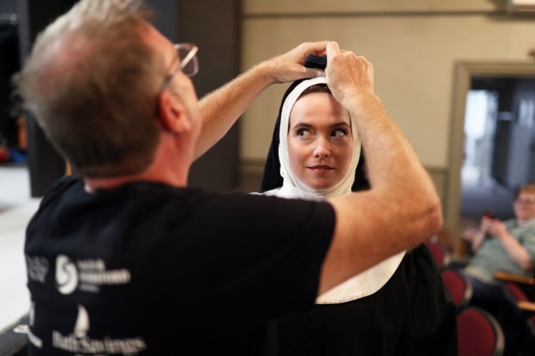 Director Joshua Chard adjusts Molly Frantzen's habit before a rehearsal of the one-person show "Sister Robert Anne's Cabaret Class," part of the Nunsense franchise, at Lyric Music Theater in South Portland.